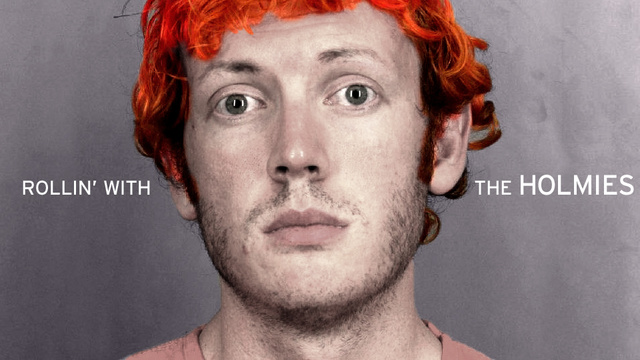 Politiefoto van een man met feloranje haar, met de tekst “Rollin’ with the Holmies”.