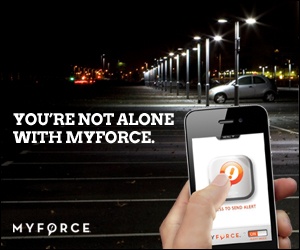 Advertentie van MyForce: een hand met een smartphone met een alarmknop op een verlaten parkeerterrein in het donker, met de tekst “You’re not alone with MyForce.”