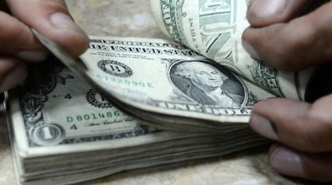 Handen tellen een stapel dollarbiljetten van 1 dollar.