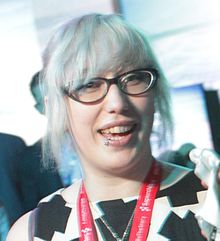 Portret van gamemaker Zoe Quinn met lichtgeverfd haar en bril, tijdens de Game Developers Conference in 2014.
