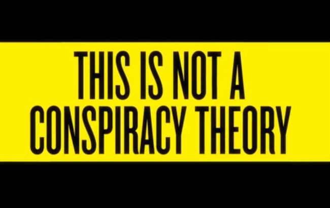 Zwarte letters op een gele balk met de tekst “This is not a conspiracy theory”.